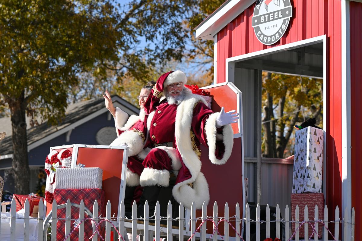 Santa and Mrs. Claus riding on the American Steel parade float